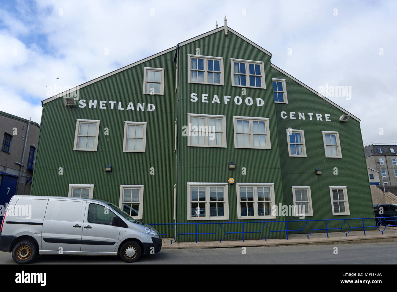 Stewart Building in Shetland on the quayside home to the Shetland Seafood Centre and SNH with signage on the outside of the building Stock Photo