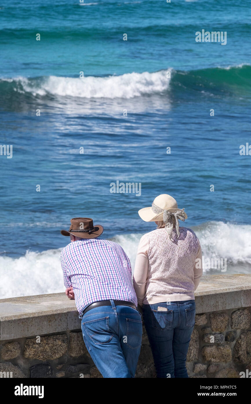 Holidaymakers enjoying the view at Sennen Cove in Cornwall. Stock Photo
