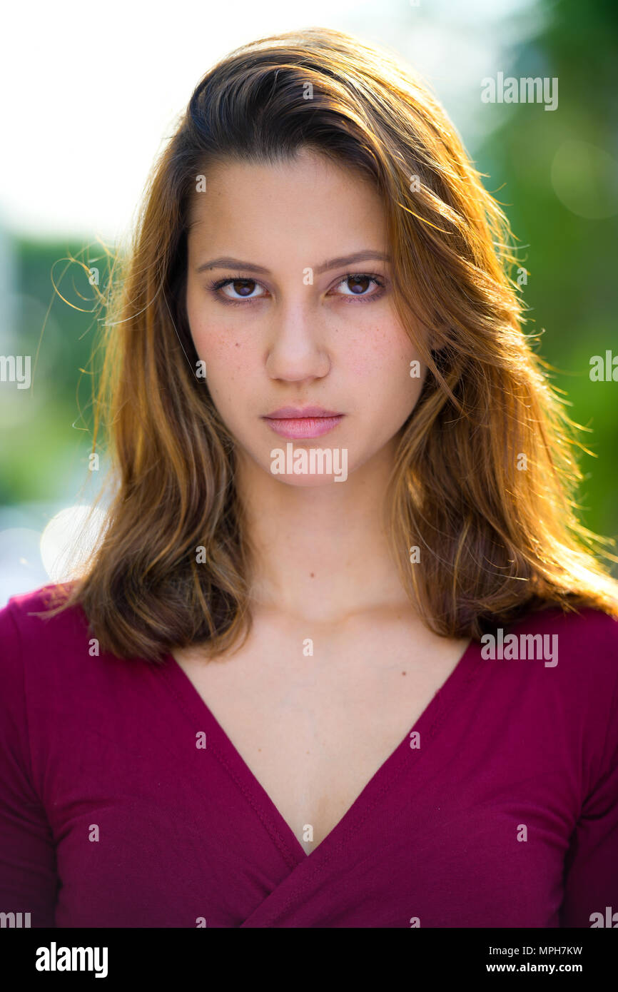 Young beautiful multi-ethnic woman in the streets outdoors Stock Photo