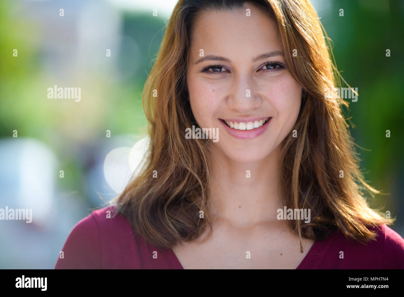 Young beautiful multi-ethnic woman in the streets outdoors Stock Photo
