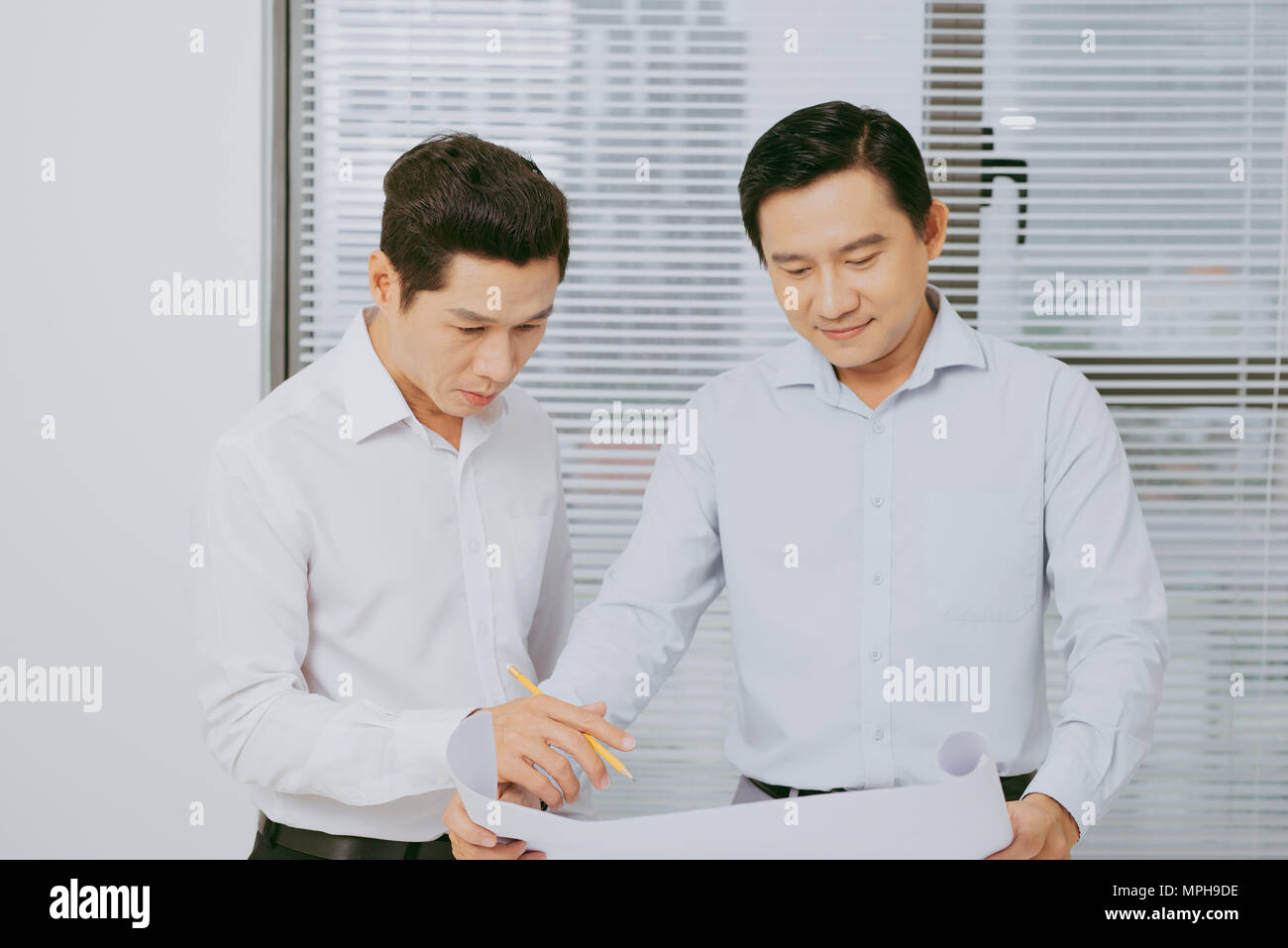 Male coworkers discussing ideas  about project in office, architectural concept Stock Photo