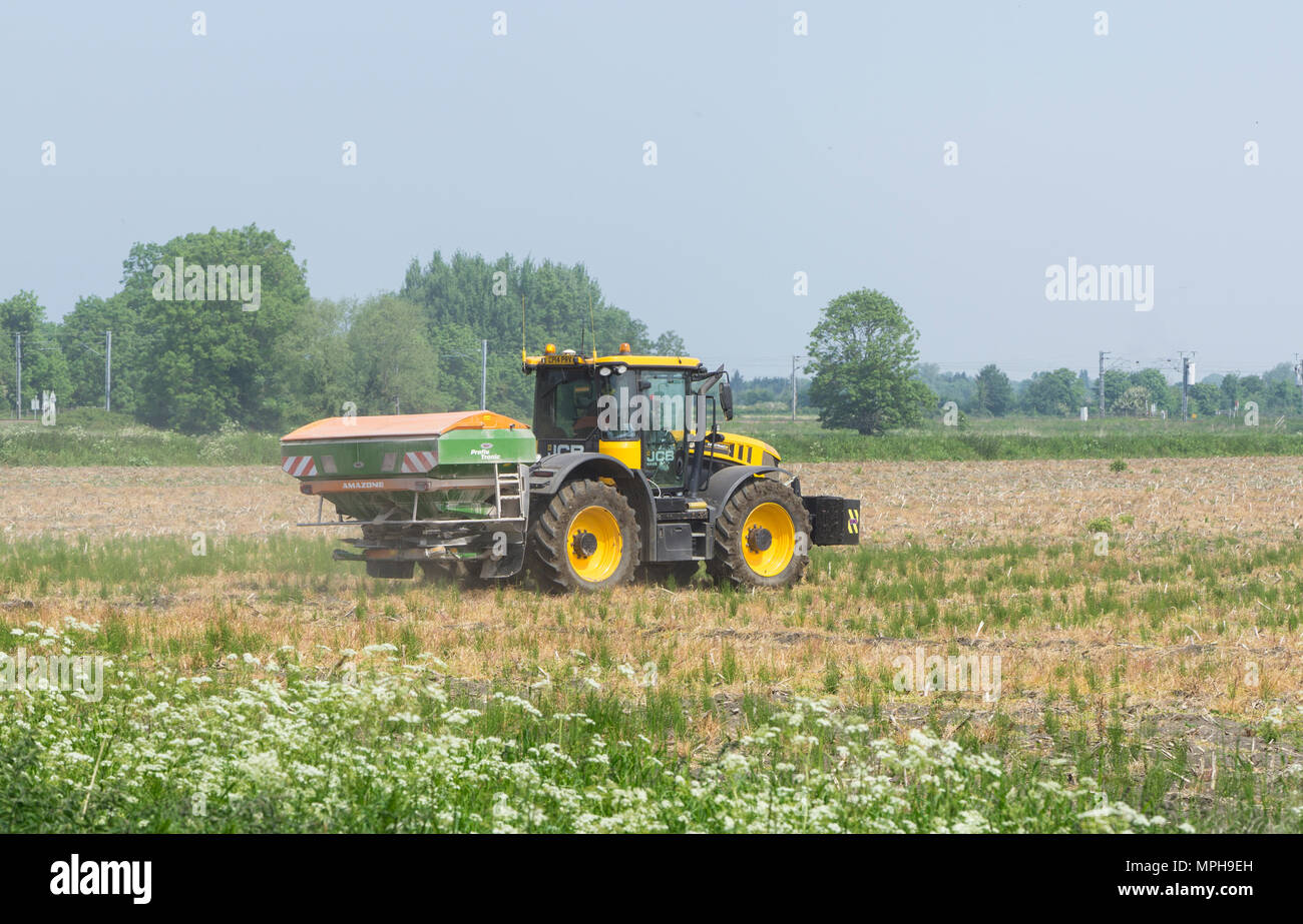 Agricultural vehicle spreading powder on fallow land Stock Photo