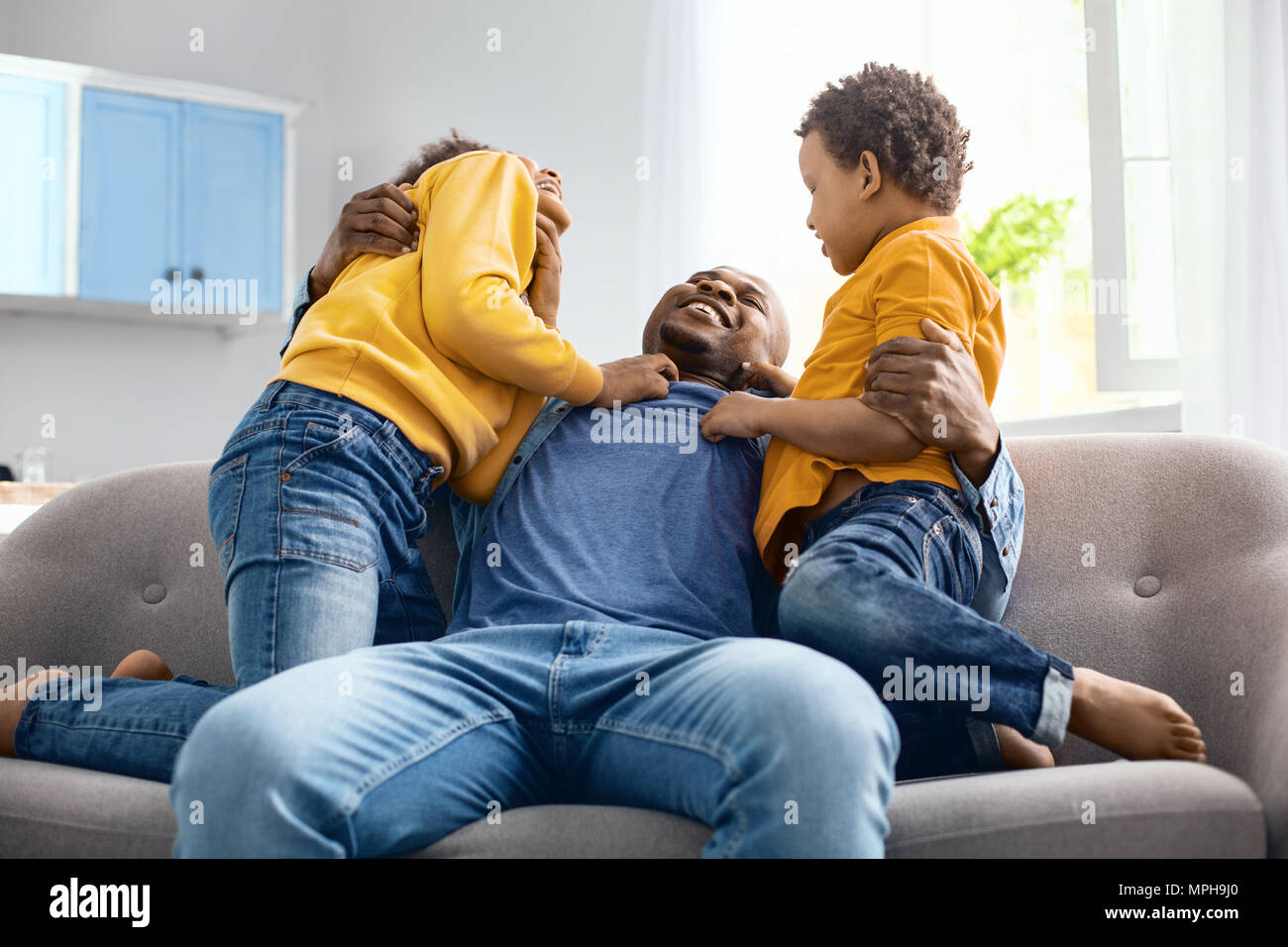Happy loving father hugging his two sons Stock Photo