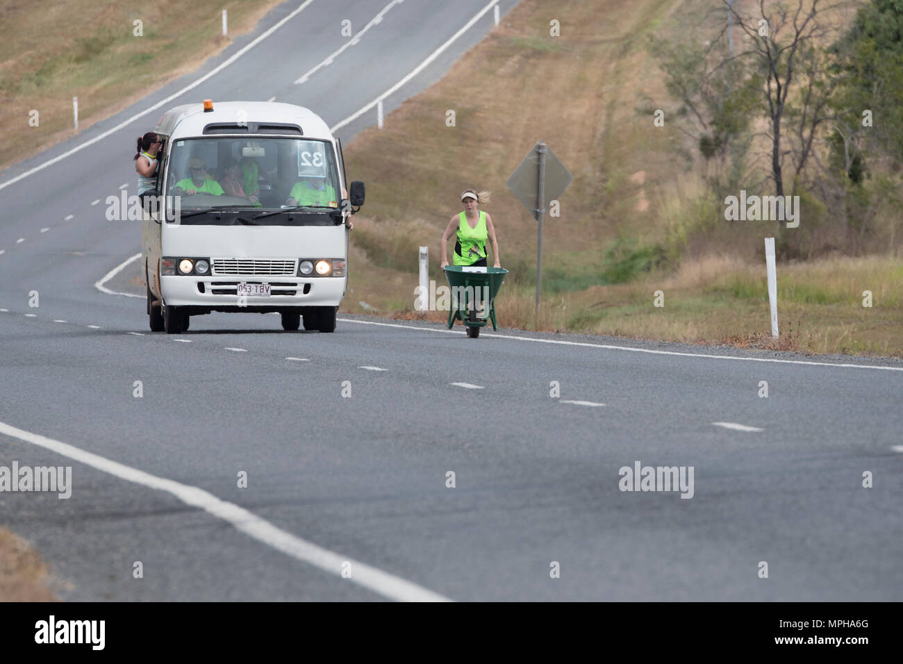 Female participant in The Great Wheelbarrow Race from Chillagoe to Mareeba, a fundraising event in Far North Queensland, FNQ, QLD, Australia Stock Photo