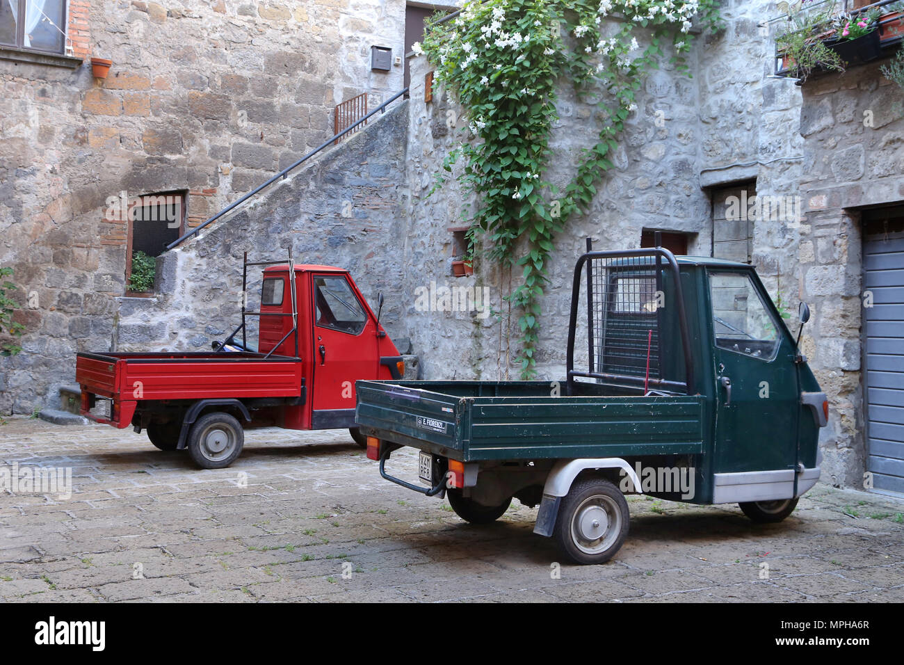 BOLSENA, ITALY - JUNE 28, 2015:picturesque old street with dwellings and an ancient italian vehicle Ape Piaggio in the Bolsena, Lazio. Stock Photo