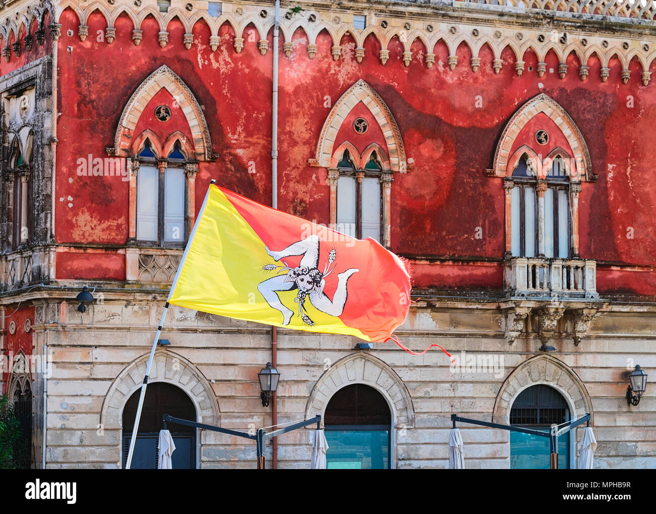 Sicilian falg at an ancient building in Siracusa, Sicily, Italy Stock Photo