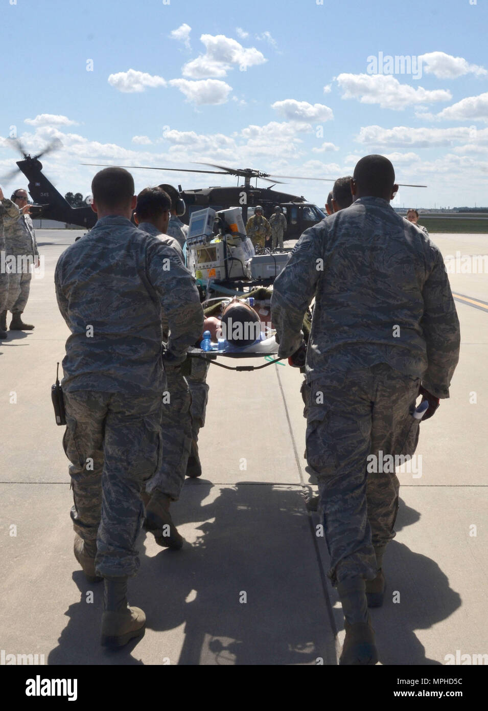 A team of Air Force Reserve rescue medics load a simulated patient connected to an extracorporeal membrane oxygenation machine onto an Army National Guard UH-60 Black Hawk helicopter March 4, 2017 at Patrick Air Force Base, Florida, as part of the 5th annual MEDBEACH joint medical response exercise. More than 250 military medics from 12 units across the country participated in this year's exercise. (U.S. Air Force photo/Capt. Leslie Forshaw) Stock Photo