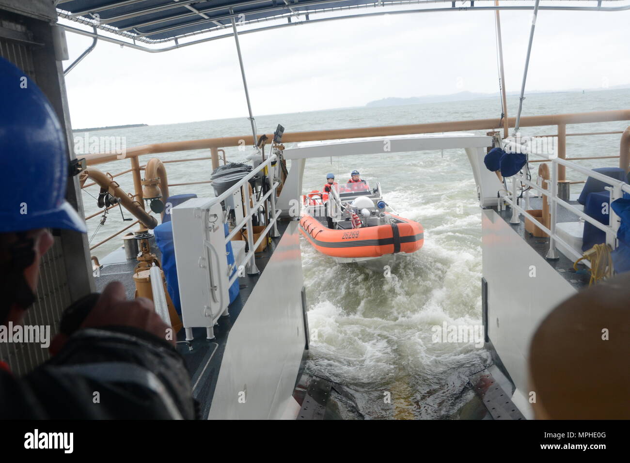 the-crew-of-the-coast-guard-cutter-john-mccormick-wpc-1121-launches-their-small-boat-from-the-stern-boat-ramp-in-preparation-for-mooring-in-astoria-oregon-march-11-2017-the-new-fast-response-cutter-has-increased-capabilities-compared-to-the-smaller-110-foot-patrol-boats-it-is-replacing-including-safer-small-boat-launch-and-recover-via-the-stern-ramp-the-john-mccormick-is-the-first-frc-on-the-west-coast-us-coast-guard-photo-by-lt-brian-dykens-MPHE0G.jpg
