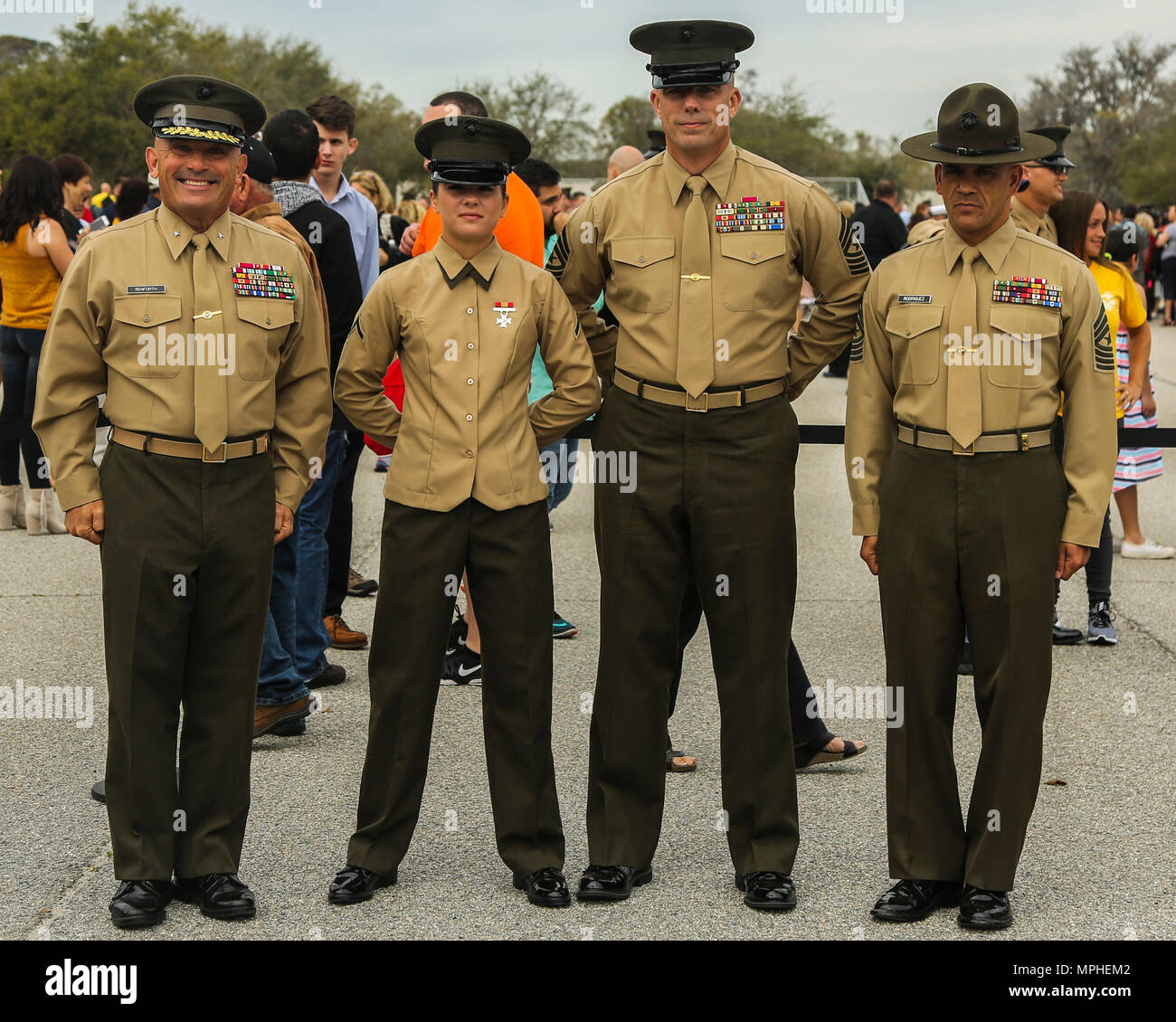 (From left to right) U.S. Marine Corps Brig. Gen. Austin Renforth, commanding general of Marine Corps Recruit Depot Parris Island/Eastern Recruiting Region, Pfc. Madeline Kreamer, Sgt. Maj. Howard Kreamer, the sergeant major of 2nd Marine Aircraft Wing, and Sgt. Maj. Rafael Rodriguez, Marine Corps Recruit Depot Parris Island/Eastern Recruiting Region Sergeant Major, pose for a photo after a graduation ceremony on Marine Corps Recruit Depot, Parris Island, S.C., March 10, 2017. The ceremony is conducted to honor the new Marines. (U.S. Marine Corps photo by Lance Cpl. Colby Cooper/released) Stock Photo
