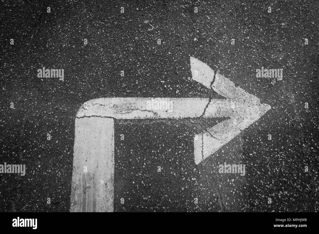 Right arrow sign on asphalt Stock Photo