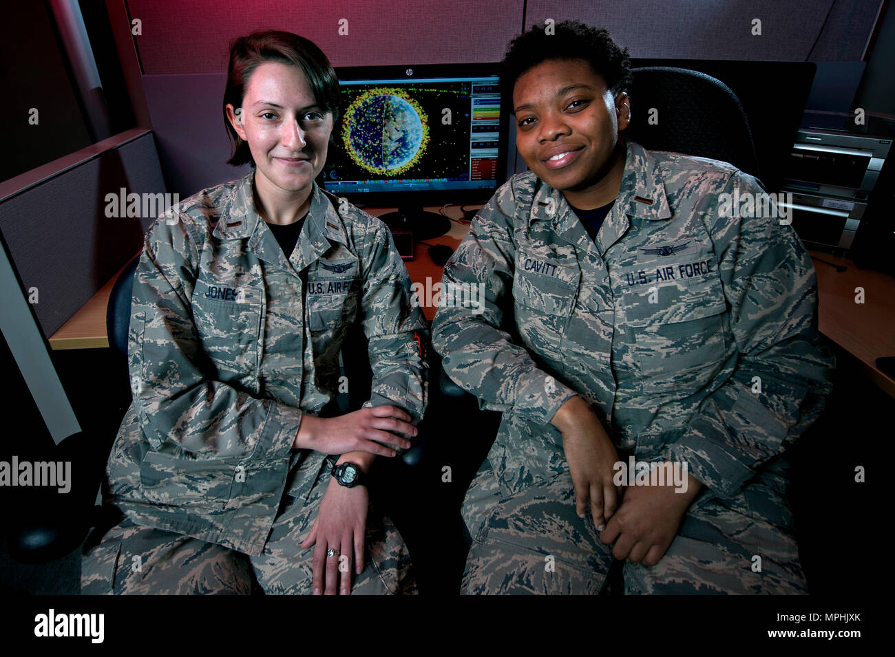 SCHRIEVER AIR FORCE BASE, Colo. -- Second Lts. Ranell Cavitt and Maggie Jones, 3rd Space Experimentation Squadron, have been nearly inseparable since they arrived at Schriever Air Force Base, Sept. 30, 2015. They have only been separated professionally for a short time, during training, since their arrival and work closely together as Automated Navigation and Guidance Experiment in Local Space satellite mission planners and trainers. Their shared experience and passion for space and science helped build a friendship and camaraderie that appears like a life-long bond, though the pair met less t Stock Photo