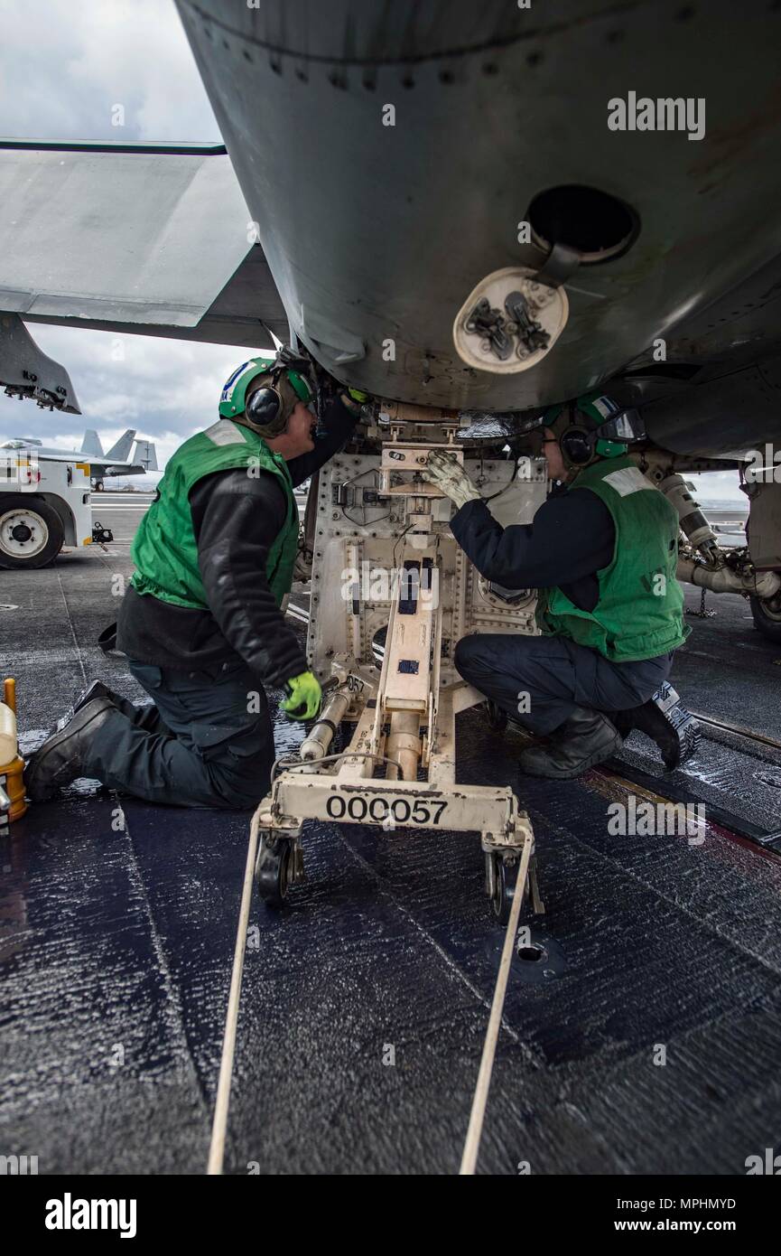 170315-N-OS569-028  ATLANTIC OCEAN (March 15, 2017) Aviation Machinist’s Mate Airmen Anthony Molina, left, from Edna, Texas, and Aviation Machinist’s Mate Airman Austin Turner, from Harrisburg, Pa., conduct maintenance on aircraft on the flight deck of the aircraft carrier USS Dwight D. Eisenhower (CVN 69) (Ike). Ike is currently conducting aircraft carrier qualifications during the sustainment phase of the Optimized Fleet Response Plan (OFRP). (U.S. Navy photo by Mass Communication Specialist Seaman Zach Sleeper) Stock Photo