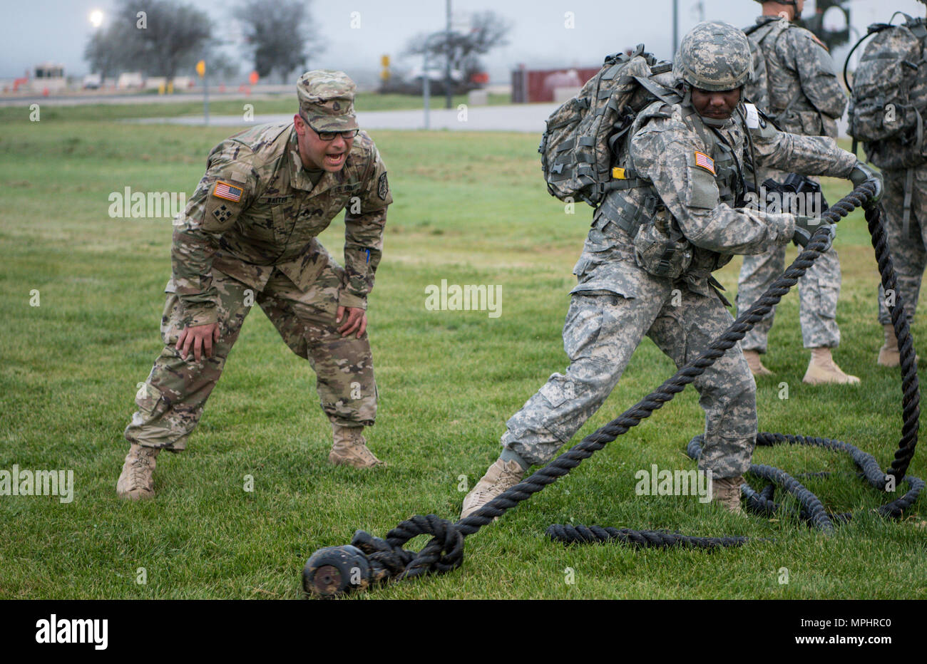 Spc. Arne Fisher from the 290th Military Police Brigade, pulls a 50 pound  weight attached to a rope during the first stage of the physical readiness  event for this year's 200th Military