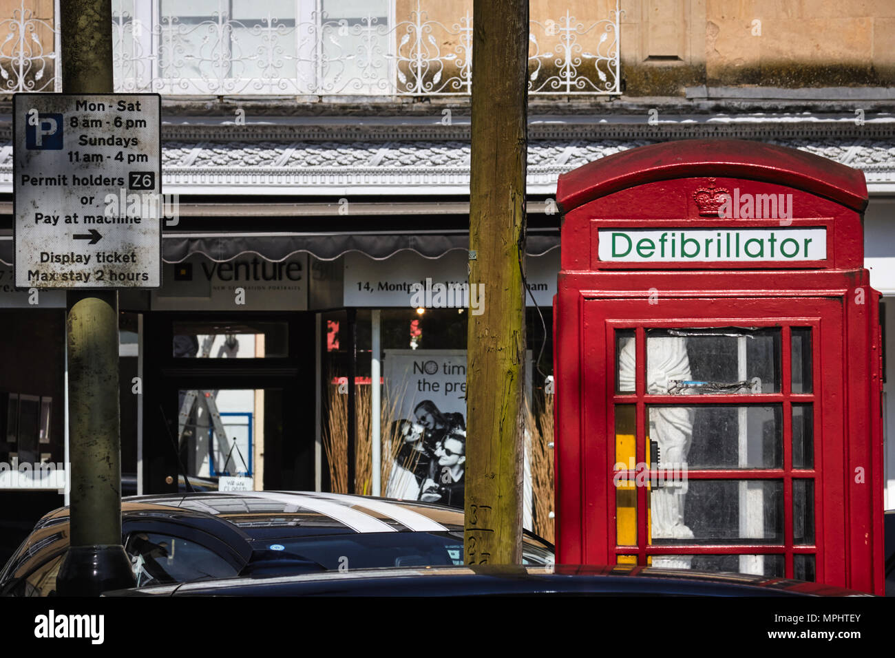 Traditional British red telephone box converted to a public / street defibrillator. Montpellier, Cheltenham, Gloucestershire Stock Photo