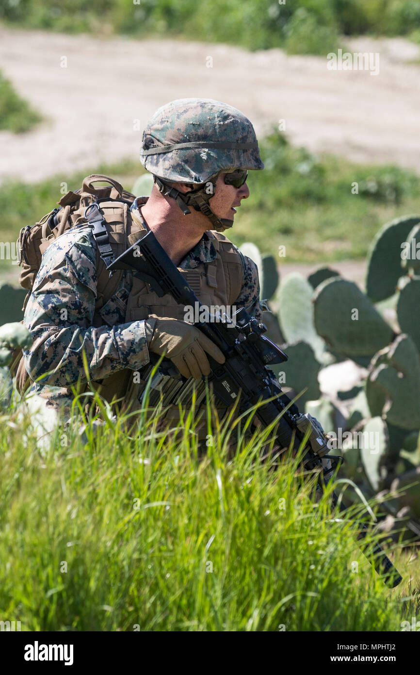 U.S. Marine Corps Cpl. Tylor Snow, rifleman, 3rd Battalion, 5th Marine Regiment provides security during a raid rehearsal at Camp Pendleton, Calif., March 16, 2017. Marines with 3rd Battalion, 5th Marine Regiment are training to maintain unit proficiency and preparing to deploy with the 15th Marine Expeditionary Force. (U.S. Marine Corps photo by Lance Cpl. Rhita Daniel) Stock Photo