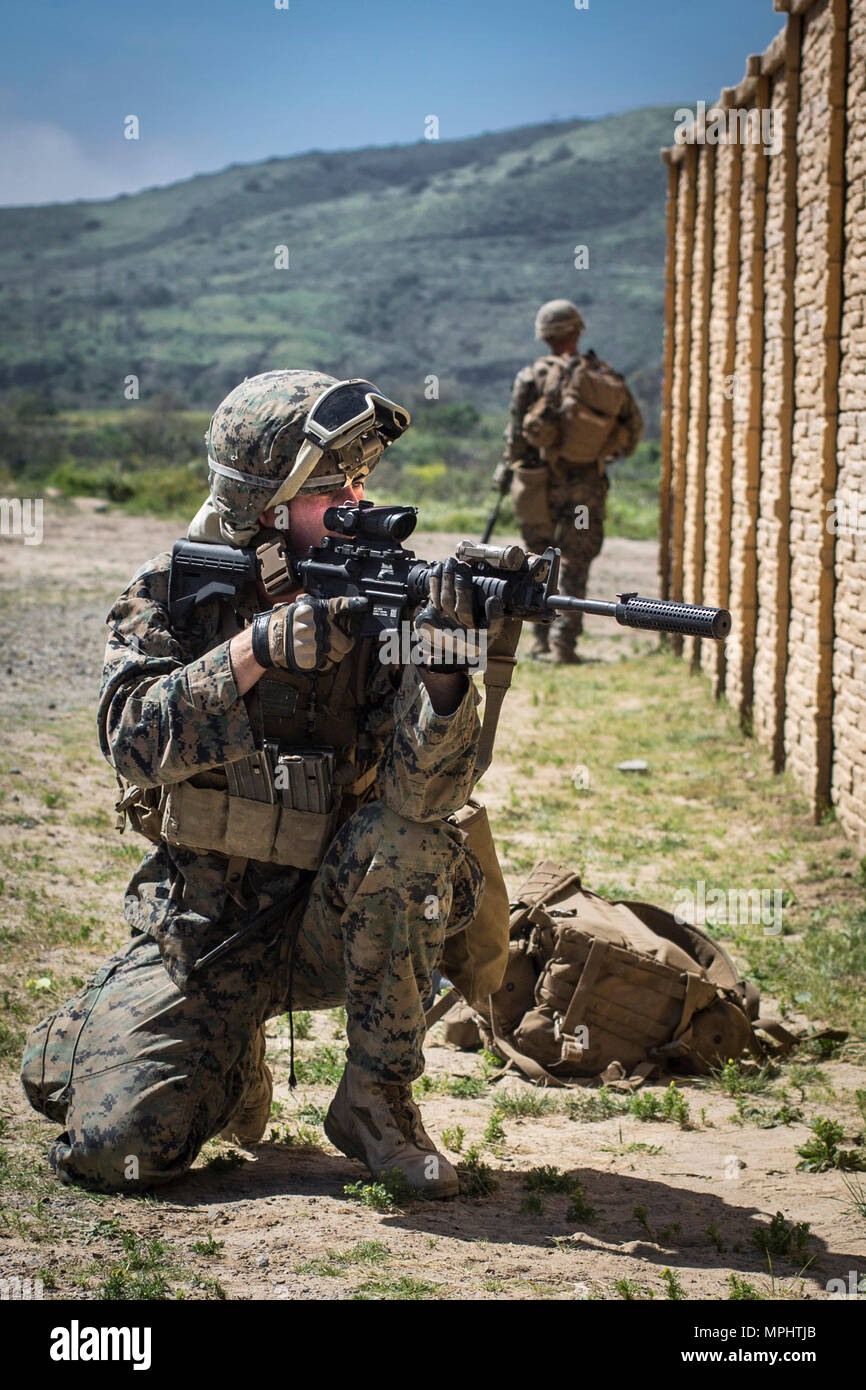 U.S. Marine Corps Cpl. Tylor Snow, rifleman, 3rd Battalion, 5th Marine Regiment provides security during a raid rehearsal at Camp Pendleton, Calif., March 16, 2017. Marines with 3rd Battalion, 5th Marine Regiment are training to maintain unit proficiency and preparing to deploy with the 15th Marine Expeditionary Force. (U.S. Marine Corps photo by Lance Cpl. Rhita Daniel) Stock Photo