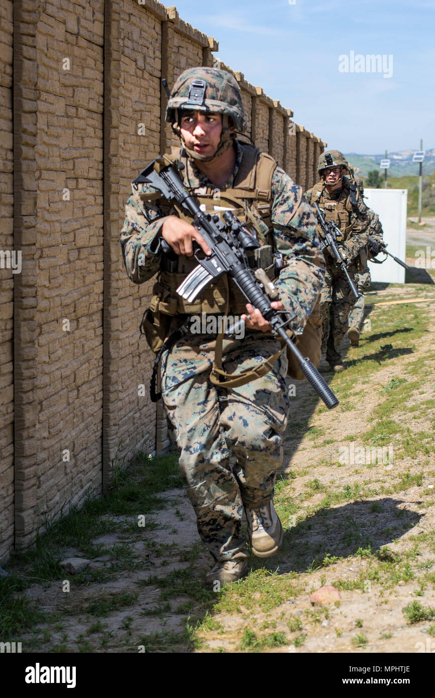 U.S. Marine Corps Cpl. Edgardo Gonzalez, rifleman, 3rd Battalion, 5th Marine Regiment buddy-rushes during a raid rehearsal at Camp Pendleton, Calif., March 16, 2017. Marines with 3rd Battalion, 5th Marine Regiment are training to maintain unit proficiency and preparing to deploy with the 15th Marine Expeditionary Force. (U.S. Marine Corps photo by Lance Cpl. Rhita Daniel) Stock Photo