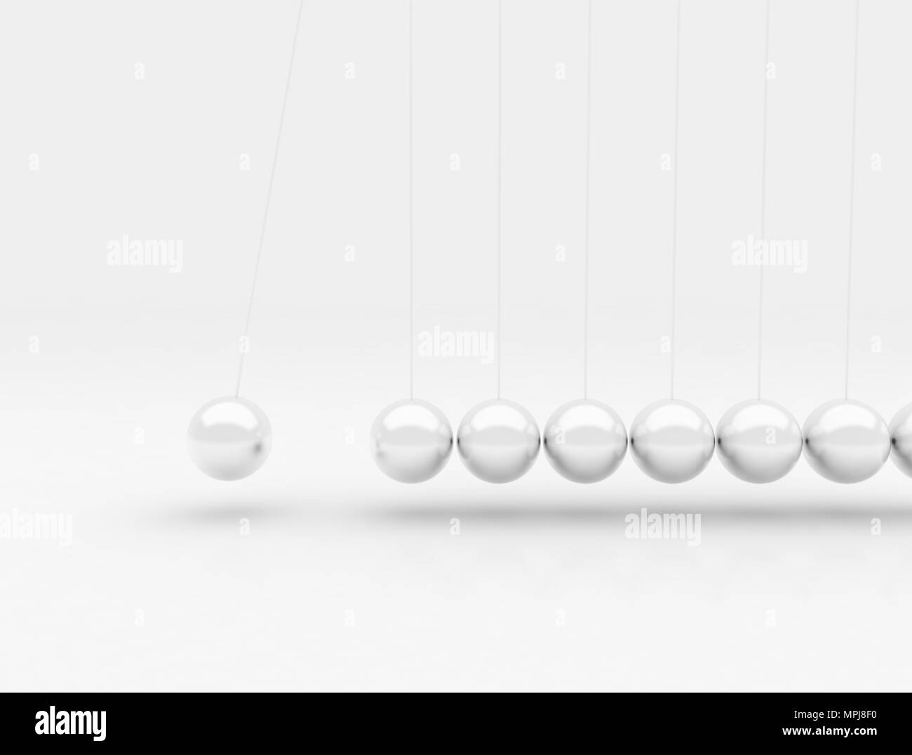 Newtons cradle silver metal balls in motion Stock Photo
