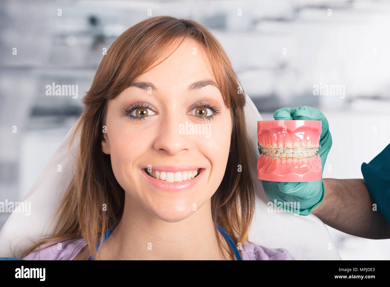 Dentist shows how to apply a brace Stock Photo Alamy
