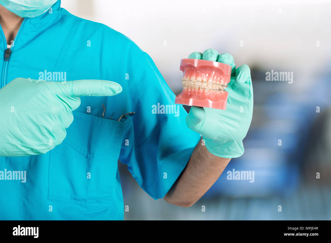 Dentist shows how to apply a brace Stock Photo