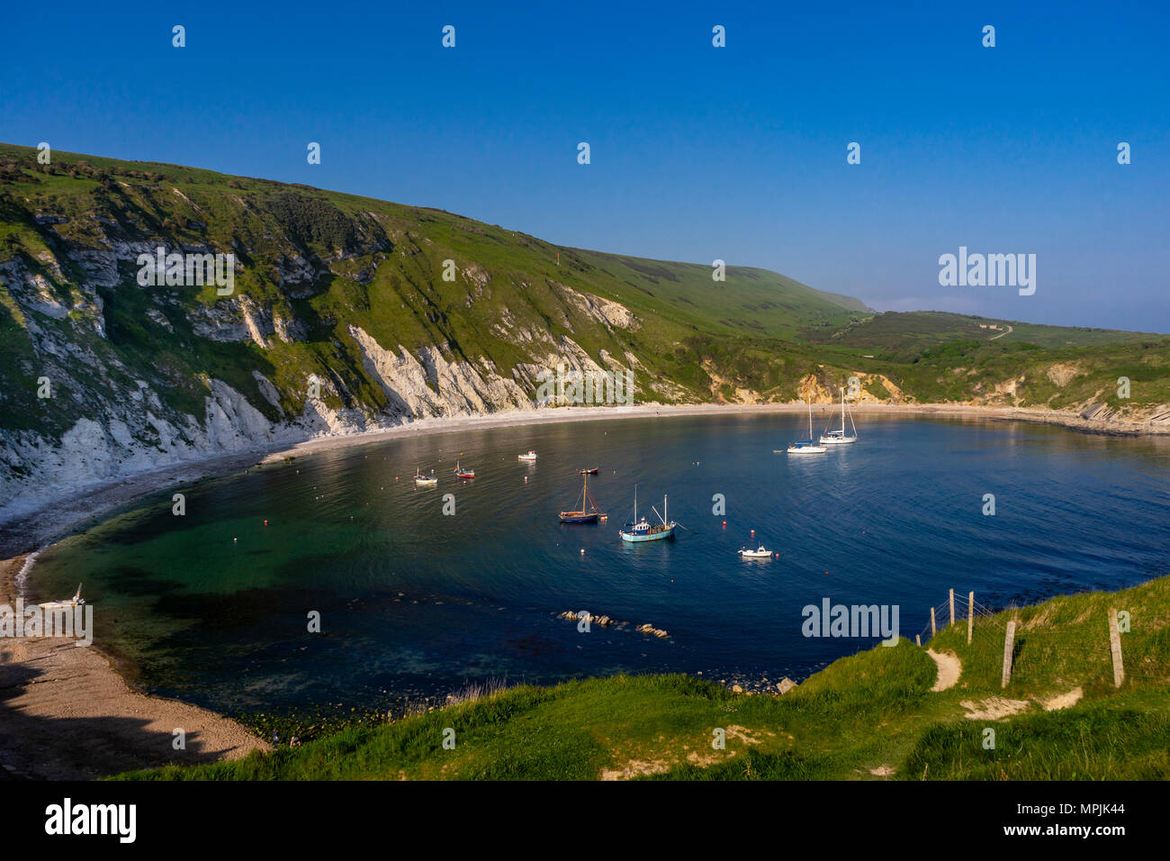 Scenic view over Lulworth Cove, part of the Jurassic Coast UNESCO Natural World Heritage site in Dorset, England, UK Stock Photo