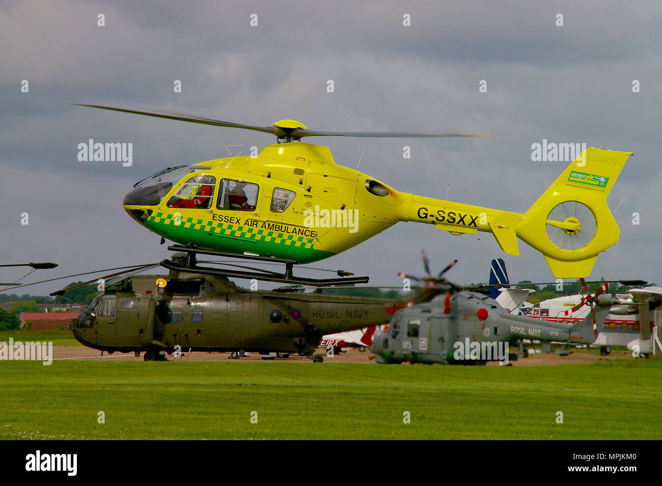 Essex Air Ambulance helicopter Eurocopter EC135 G-SSXX, landing at Southend airport during the airshow with Sea King and Lynx military helicopters Stock Photo