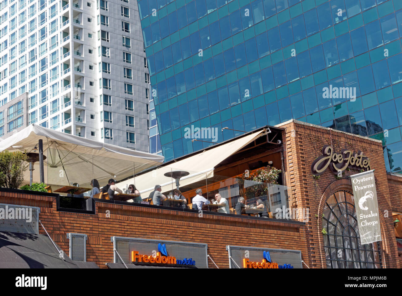 People dining on the rooftop patio of Joe Fortes steak and seafood restaurant on Thurlow Street in downtown  Vancouver, BC, Canada Stock Photo