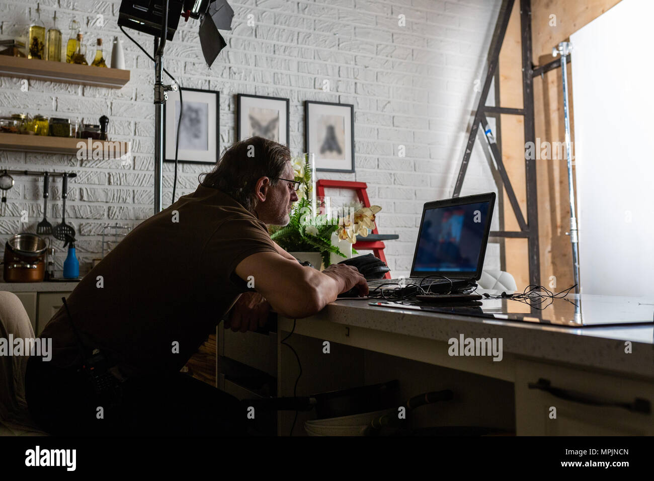 Handsome man is working in data centre with laptop. Stock Photo