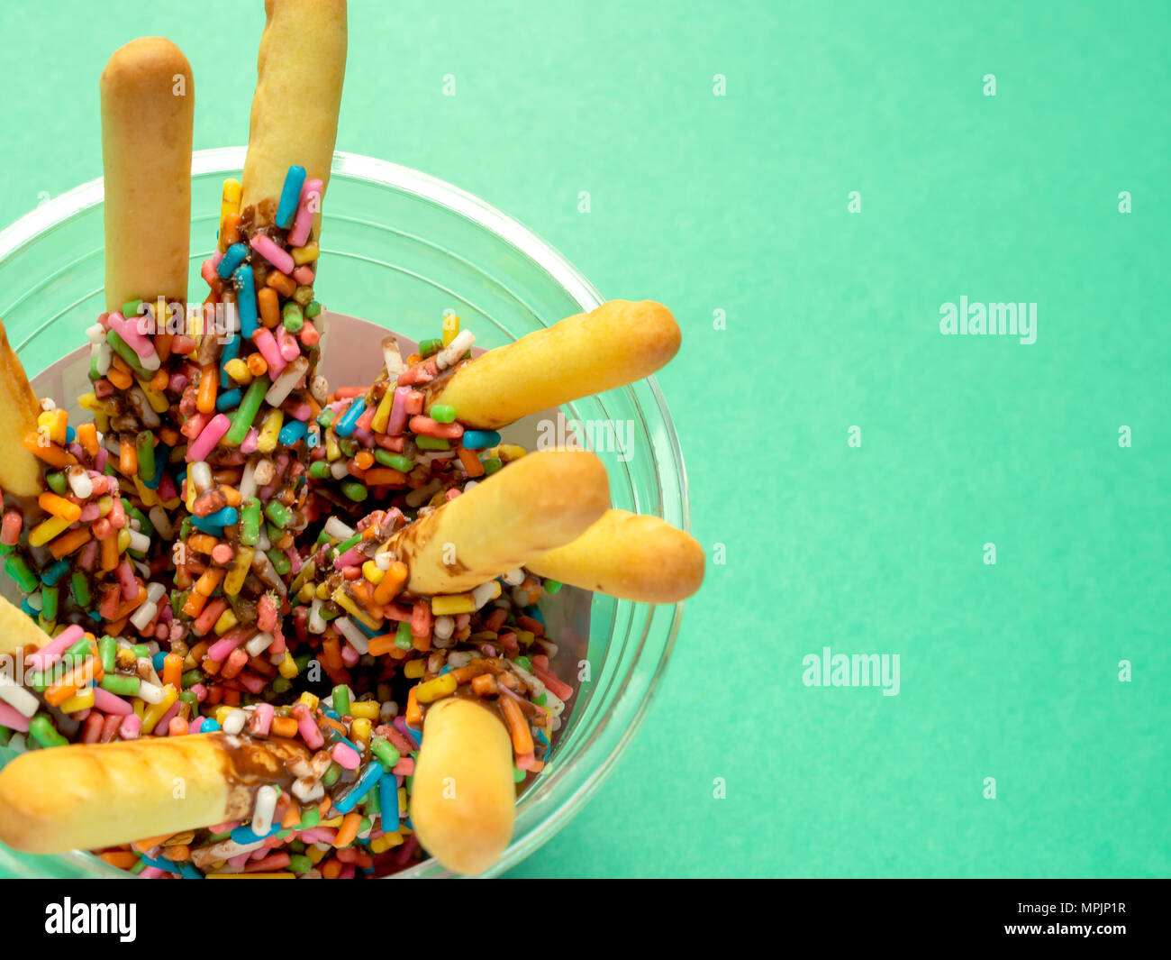 Bread Sticks with Chocolate and Colorful Topping with Space on Green