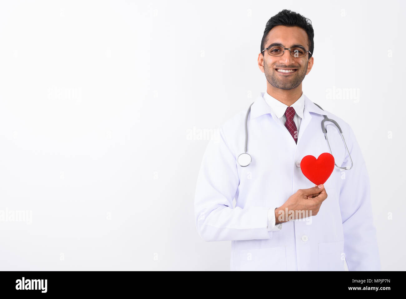 Young handsome Indian man doctor against white background  Stock Photo