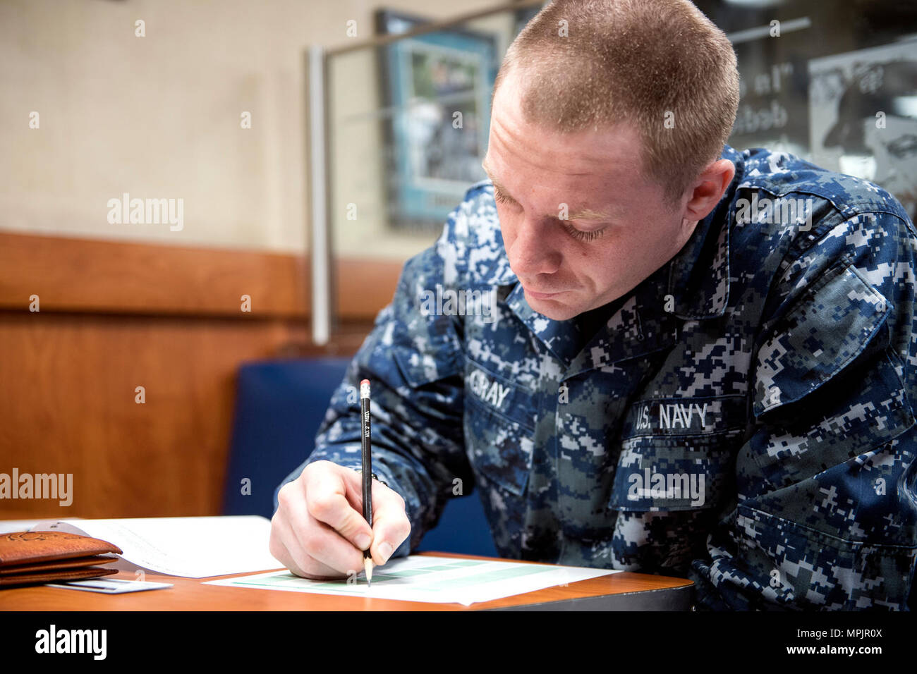 A U.S. Navy sailor completes the Navywide E-4 advancement examination ...