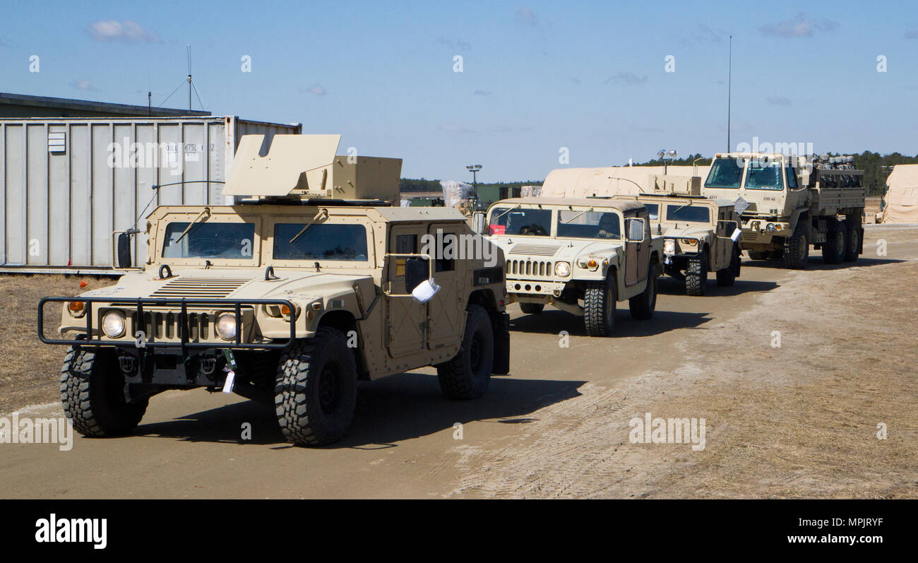A convoy of High Mobility Multipurpose Wheeled Vehicles (HMMWV) and ...