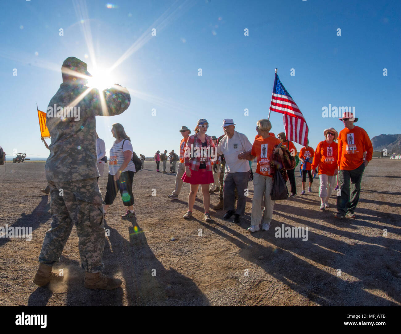 A U.S. Army Soldier snaps a quick photo of retired U.S. Army Col. Ben Skardon, a survivor of the Bataan Death March, as he walks in the Bataan Memorial Death March at White Sands Missile Range, N.M., March 19, 2017. (U.S. Army Reserve photo by Staff Sgt. Ken Scar) Stock Photo