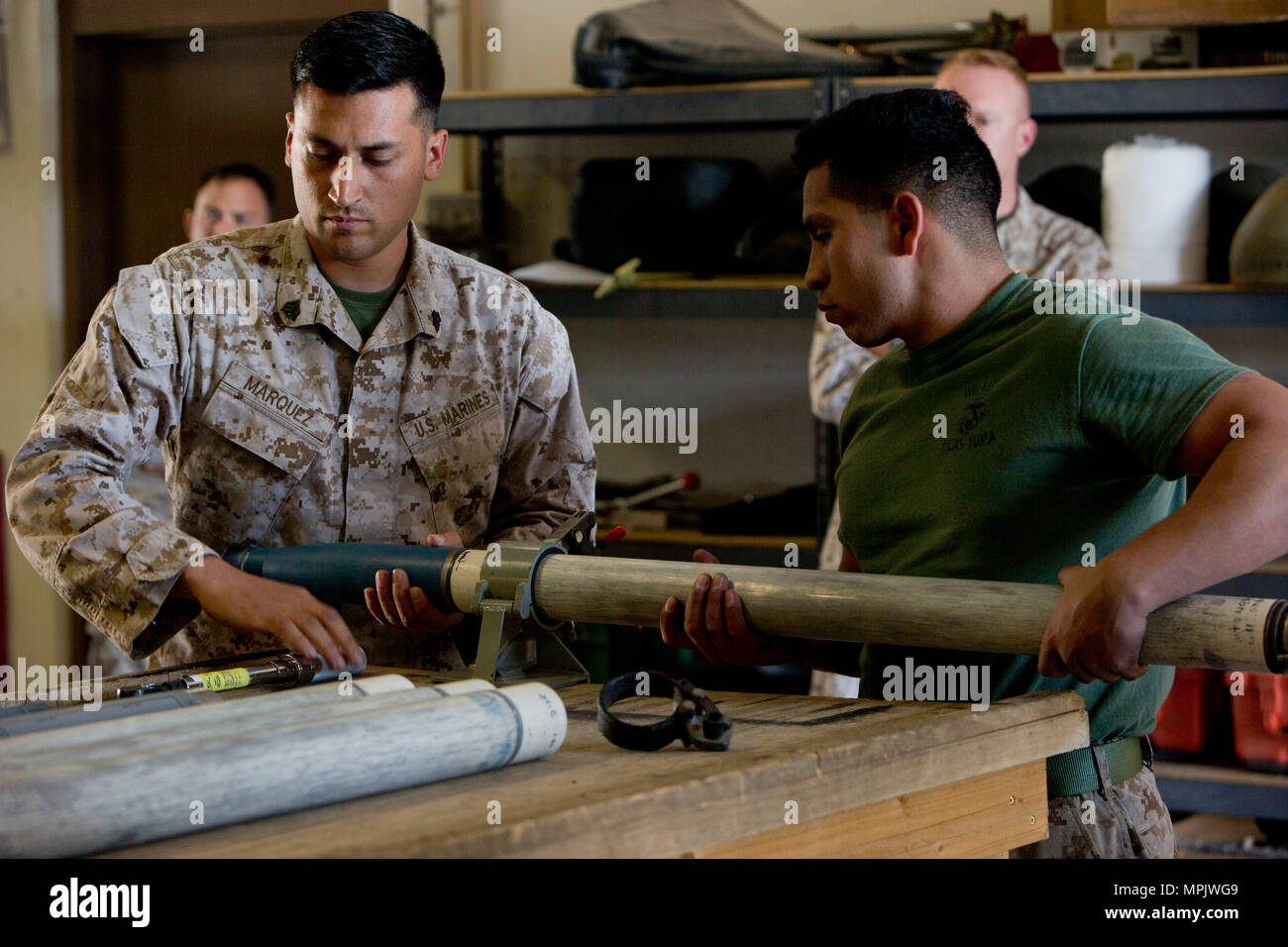 U.S. Marine Corps Sgt. Rodrigo Marquez, left, and Cpl. Jose S. Ramirez, aviation ordnance system technicians with Marine Aviation Logistics Squadron 39 (MALS-39) give a period of instruction on the Advance Precision Kill Weapon System II (APKWS II) during the first ever Aircraft Maintenance Officer Course (AAMOC) at Marine Corps Air Station Yuma, Ariz., March 17, 2017. AAMOC will empower Aircraft Maintenance Officers with leadership tools, greater technical knowledge, and standardized practices through rigorous academics and hands on training in order to decrease ground related mishaps and inc Stock Photo