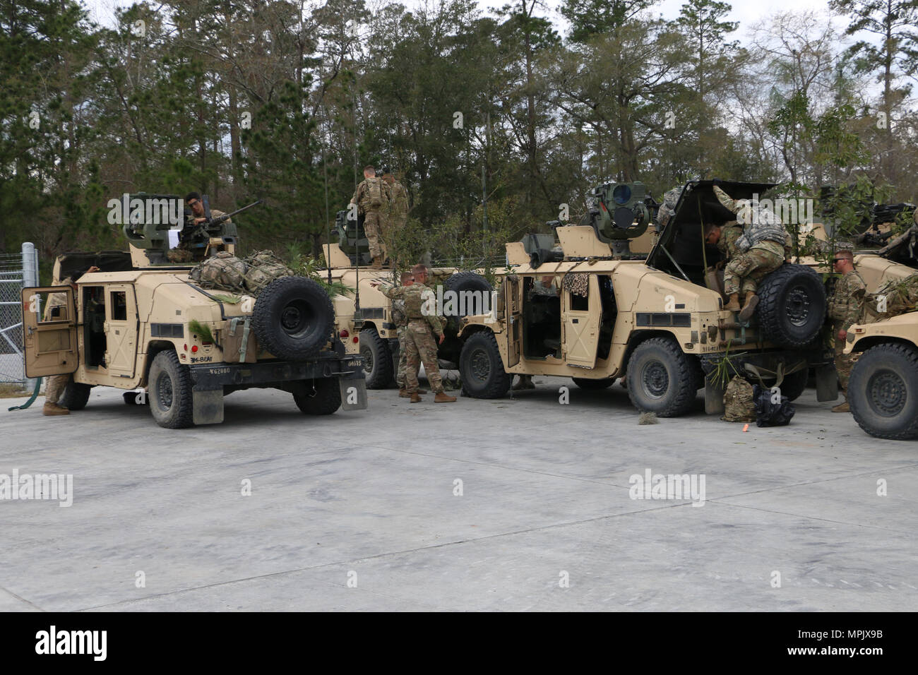 Soldiers of 6th Squadron, 8th Cavalry Regiment, 2nd Infantry Brigade Combat Team, 3rd Infantry Division prepare weapons and vehicles for a mounted gunnery range March 8, 2017 at Fort Stewart, Ga. 6-8 Cav. Soldiers qualified with mounted weapons in preparation for a squadron field training exercise next month. (U.S. Army photo by Sgt. Robert Harris/Released) Stock Photo