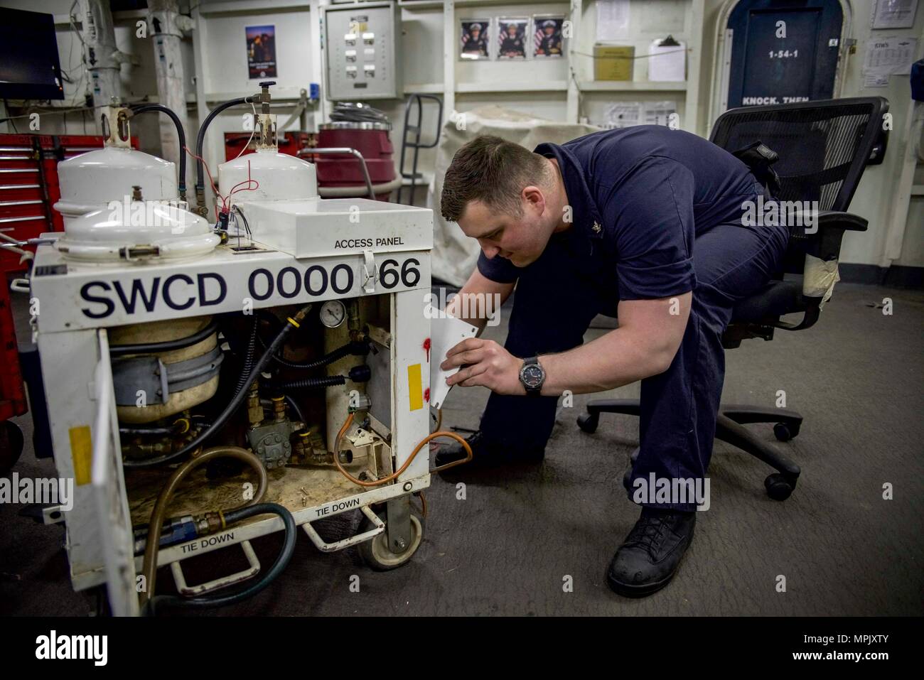170317-N-IE397-003    ATLANTIC OCEAN (March 17, 2017) Aviation Support Equipment Technician 3rd Class Adam Curry, from Half Moon, N.Y., conducts maintenance on a liquid cooling filtration unit in the aviation support equipment shop of the aircraft carrier USS Dwight D. Eisenhower (CVN 69) (Ike). Ike is currently conducting aircraft carrier qualifications during the sustainment phase of the Optimized Fleet Response Plan (OFRP). (U.S. Navy photo by Mass Communication Specialist 3rd Class Christopher A. Michaels) Stock Photo