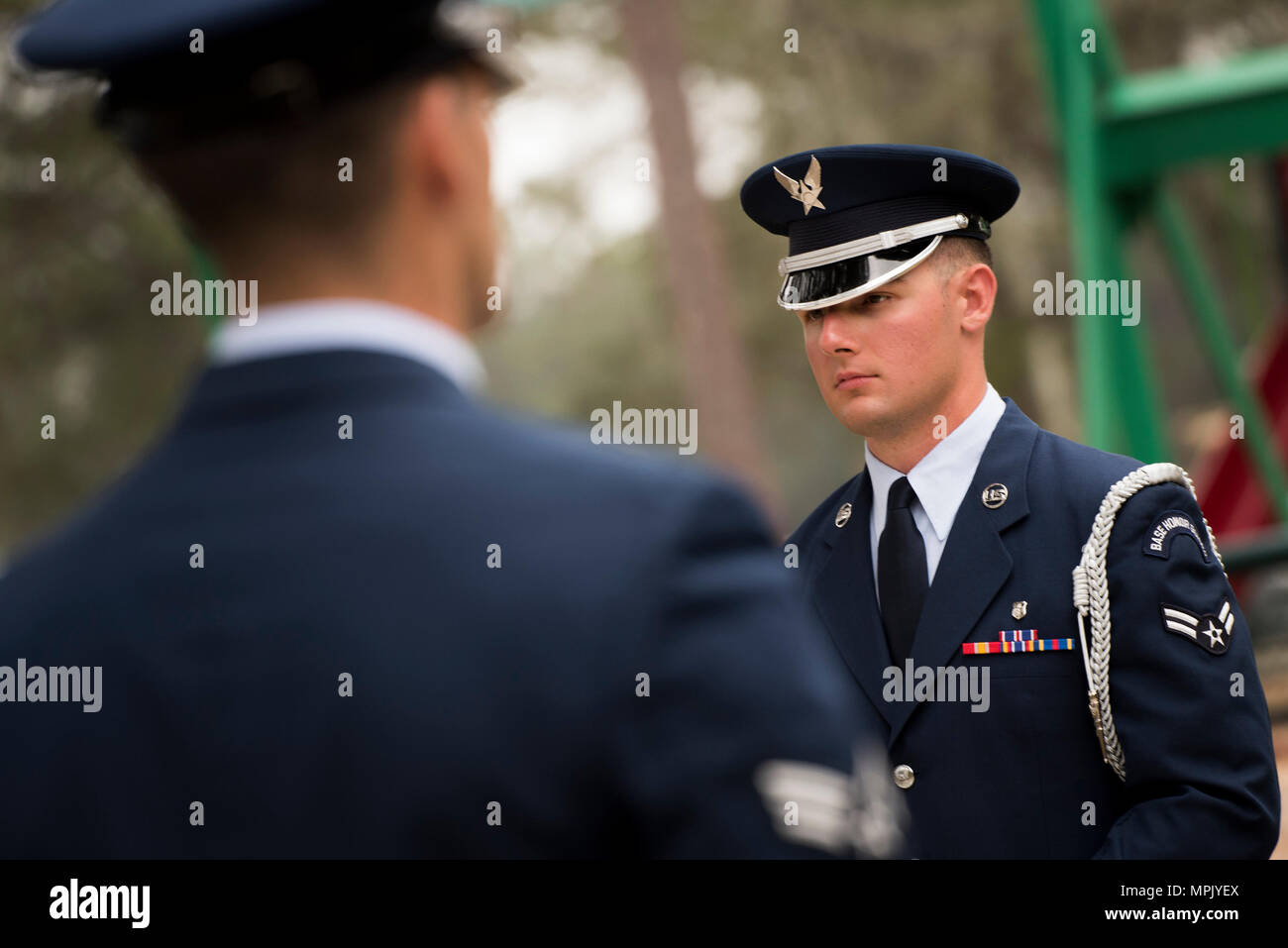 Two Honor Guard Airmen stand at attention prior to the unit’s graduation ceremony at Eglin Air Force Base, Fla., March 1.  Approximately 12 new Airmen graduated from the 120-plus-hour course. The graduation performance includes flag detail, rifle volley, pall bearers and bugler for friends, family and unit commanders. (U.S. Air Force photo/Samuel King Jr.) Stock Photo