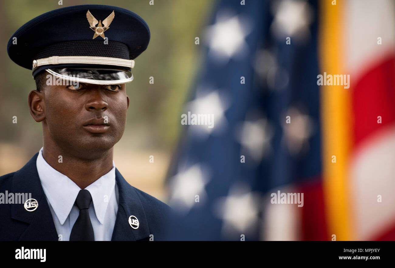 Kadeem Bell, 96th Force Support Squadron, stands by an American flag prior to the Honor Guard graduation ceremony at Eglin Air Force Base, Fla., March 1.  Approximately 12 new Airmen graduated from the 120-plus-hour course. The graduation performance includes flag detail, rifle volley, pall bearers and bugler for friends, family and unit commanders. (U.S. Air Force photo/Samuel King Jr.) Stock Photo