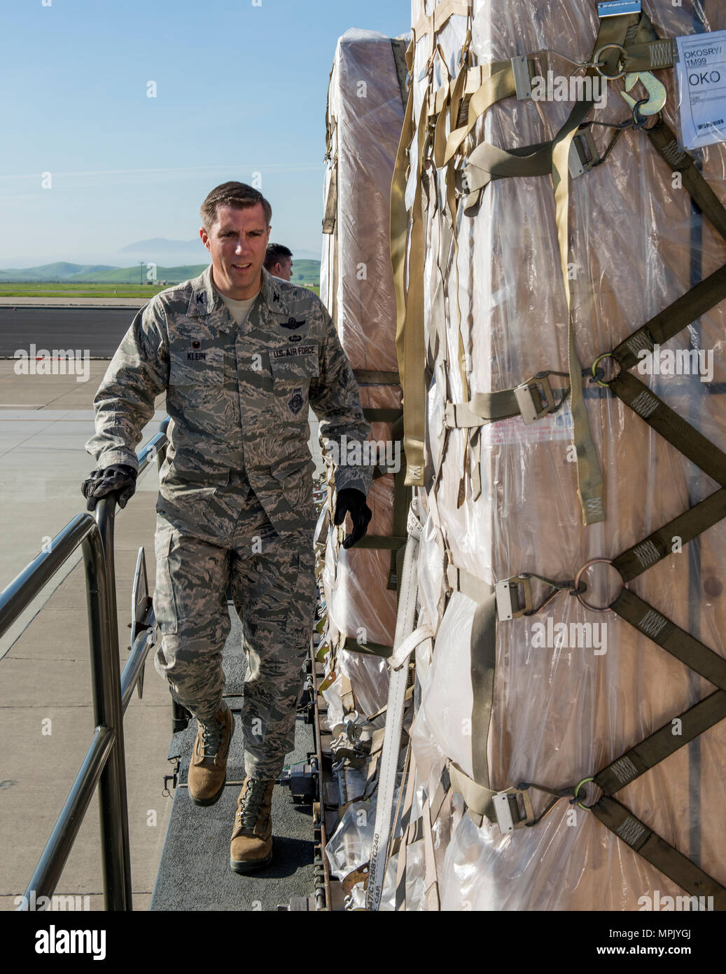 U.S. Air Force Col. John Klein, 60 Air Mobility Wing commander, prepares to move palletized cargo from a 60k Tunner loader onto a KC-10 Extender Aircraft during a Works with Airmen event at Travis Air Force Base, Calif., Mar. 17, 2017. The program is designed to allow wing leadership the opportunity to shadow junior enlisted Airmen and receive firsthand experience on how the Airman’s duties and responsibilities contribute to the wing’s overall mission. (U.S. Air Force photo  Heide Couch) Stock Photo
