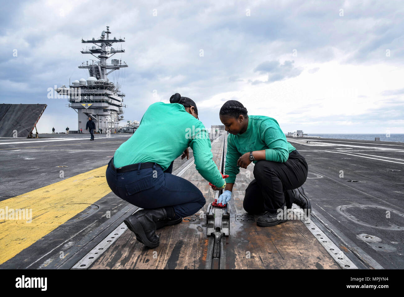 170318-N-IE397-022    ATLANTIC OCEAN (March 18, 2017) Aviation Boatswain's Mate (Equipment) Airman Wanda Ingram, from Dallas, left, and Airman Paige Boyd, from New Orleans, conduct maintenance on a steam-powered catapult on the flight deck of the aircraft carrier USS Dwight D. Eisenhower (CVN 69) (Ike). Ike is currently conducting aircraft carrier qualifications during the sustainment phase of the Optimized Fleet Response Plan (OFRP). (U.S. Navy photo by Mass Communication Specialist 3rd Class Christopher A. Michaels) Stock Photo