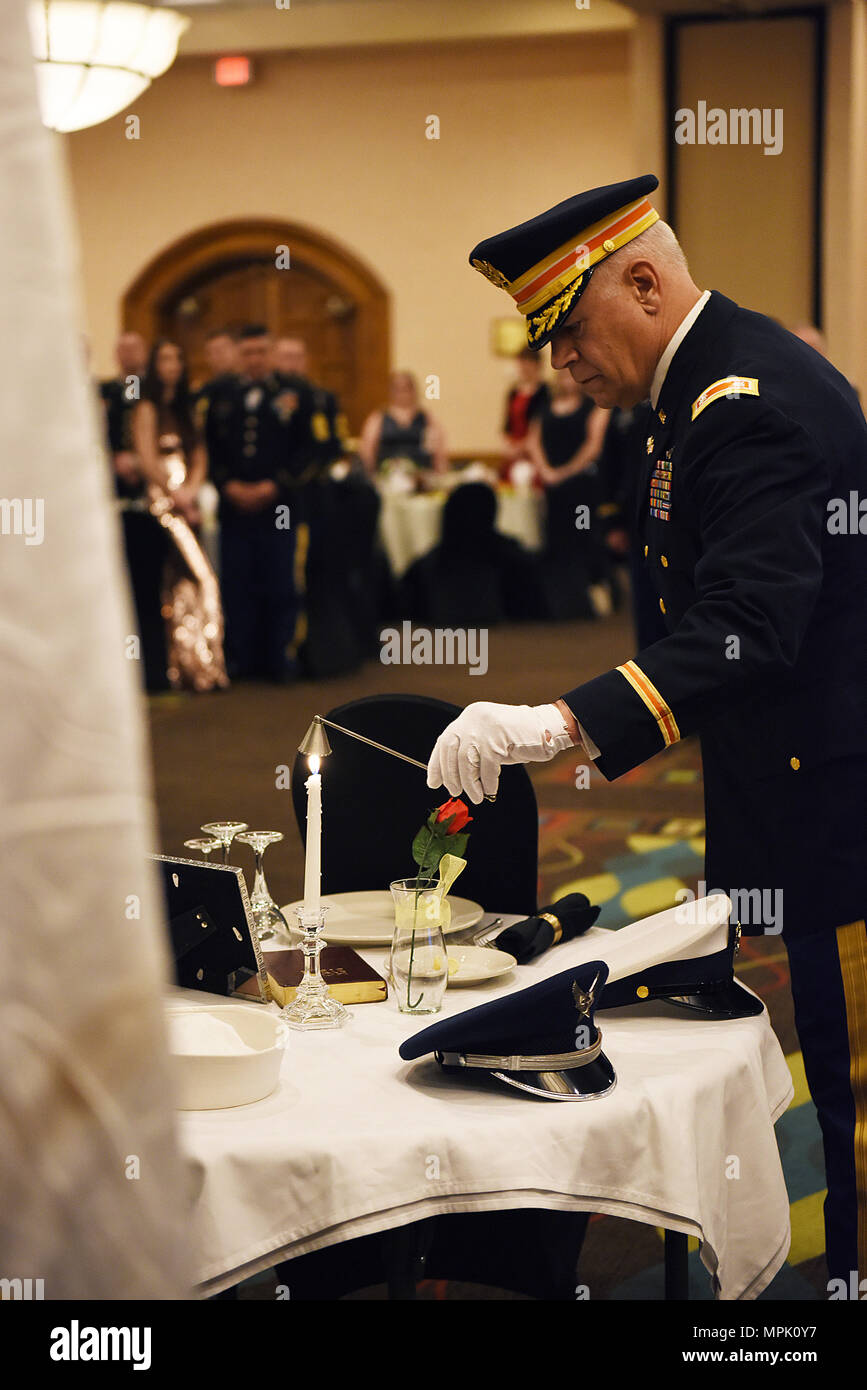 Retired Lt. Col. Dean Hagerman, from the Idaho Army National Guard, extinguishes the flame burning from a candle representing prisoners of war at the Adjutant General's Leadership Awards Banquet,held at the Riverside Hotel, Boise, Idaho. The banquet was held after leaders from the Idaho National Guard spent the day learning from the state's senior leadership at the annual TAG Leadership Day, Feb. 11, 2017. (U.S. Air National Guard photo by Master Sgt. Becky Vanshur/released) Stock Photo
