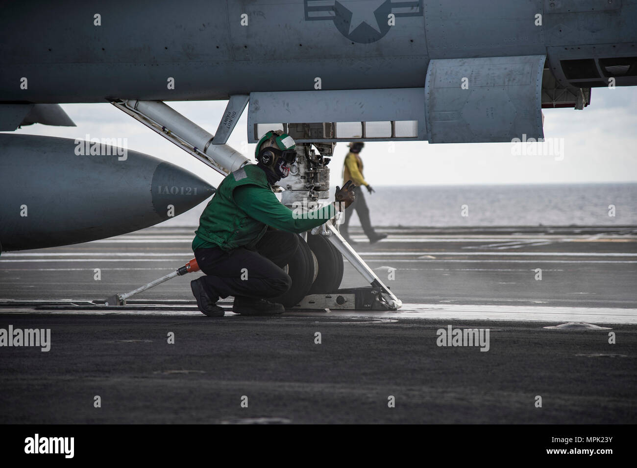 170207-N-OS569-287    ATLANTIC OCEAN (Feb 7, 2017) Aviation Boatswain’s Mate 3rd Class (Equipment) Dominic Aring, inspects the landing gear of an F/A-18E Super Hornet assigned to the Gladiators of Strike Fighter Squadron (VFA) 106 as it prepares to launch from the flight deck of the aircraft carrier USS Dwight D. Eisenhower (CVN 69) (Ike). Ike is currently conducting aircraft carrier qualifications during the Sustainment Phase of the Optimized Fleet Response Plan (OFRP). (U.S. Navy photo by Mass Communication Specialist Seaman Zach Sleeper) Stock Photo
