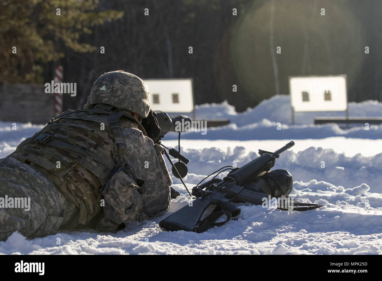 U.S. Army Spc. Saul Hernandez, infantryman, Alpha Company, 3rd Battalion, 172nd Infantry Regiment, 86th Infantry Brigade Combat Team (Mountain), Vermont National Guard, checks his grouping after a course of fire during the Vermont Best Warrior Competition at Camp Ethan Allen Training Site, Jericho, Vt., March 17, 2017.  During the three-day Best Warrior Competition, elite soldiers selected by their units are tested by board interviews, physical fitness tests, written exams, and warrior tasks relevant to today’s operating environment.  (U.S. Army National Guard Photo by 1s Lt. Benjamin Haulenbe Stock Photo