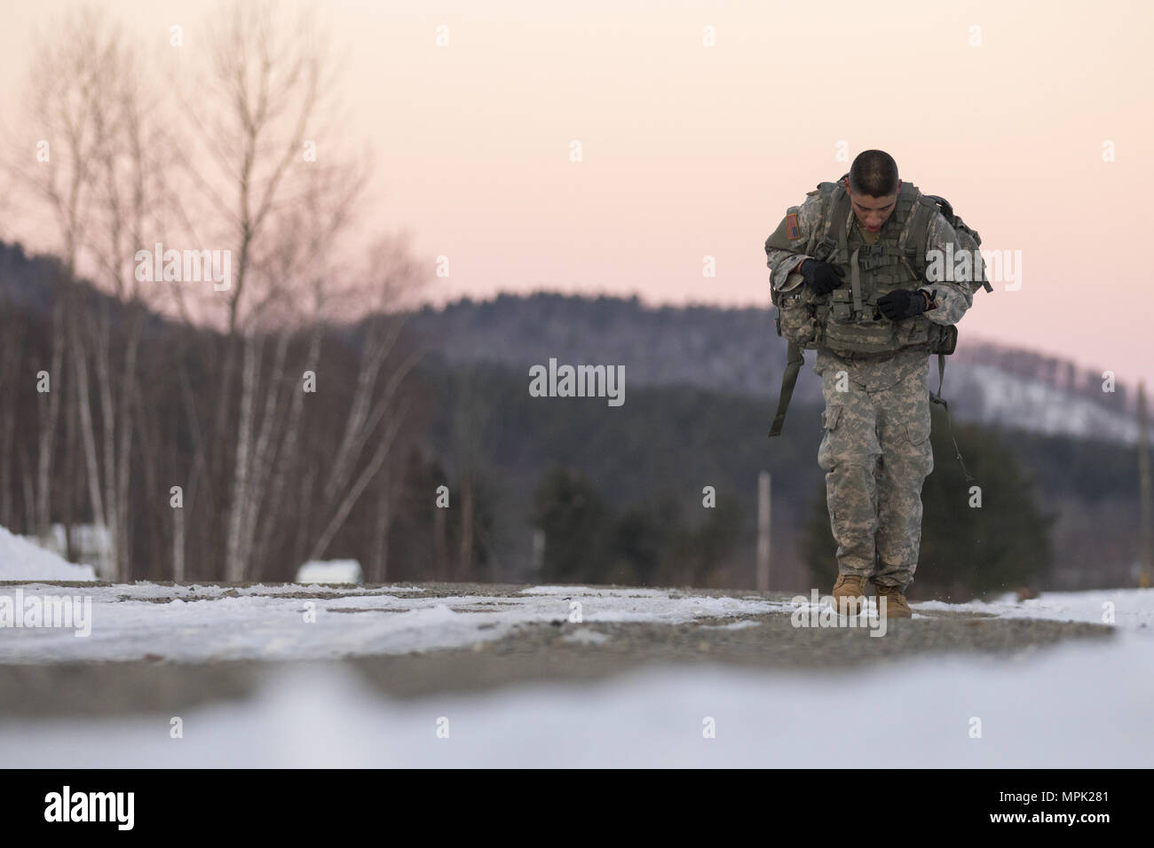 U.S. Army Spc. Saul Hernandez, infantryman, Alpha Company, 3rd Battalion, 172nd Infantry Regiment, 86th Infantry Brigade Combat Team (Mountain), Vermont National Guard, pushes himself to complete the 10-kilometer ruck march during the Vermont Best Warrior Competition at Camp Ethan Allen Training Site, Jericho, Vt., March 19, 2017.  During the three-day Best Warrior Competition, elite soldiers selected by their units are tested by board interviews, physical fitness tests, written exams, and warrior tasks relevant to today’s operating environment.  (U.S. Army National Guard Photo by 1st Lt. Benj Stock Photo