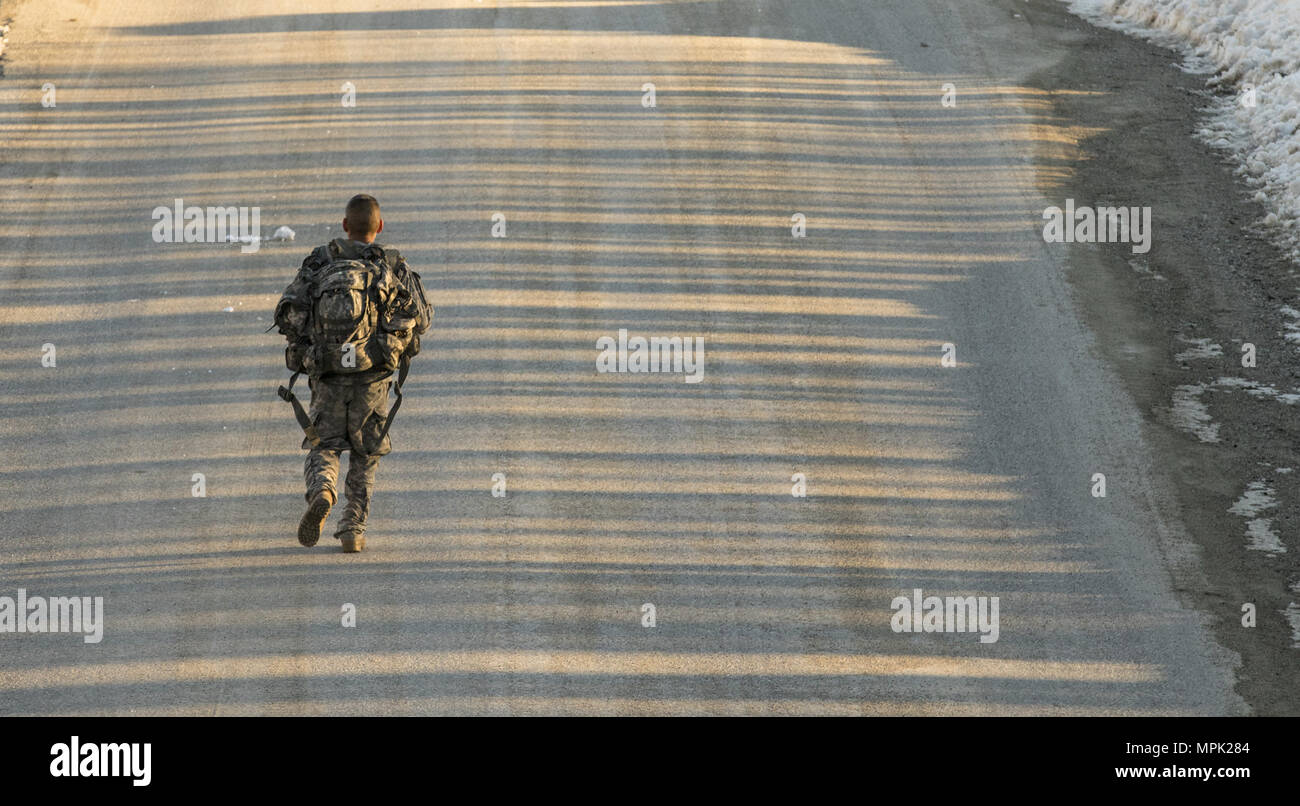 U.S. Army Spc. Saul Hernandez, infantryman, Alpha Company, 3rd Battalion, 172nd Infantry Regiment, 86th Infantry Brigade Combat Team (Mountain), Vermont National Guard, completes the 10-kilometer ruck march during the Vermont Best Warrior Competition at Camp Ethan Allen Training Site, Jericho, Vt., March 19, 2017.  During the three-day Best Warrior Competition, elite soldiers selected by their units are tested by board interviews, physical fitness tests, written exams, and warrior tasks relevant to today’s operating environment.  (U.S. Army National Guard Photo by 1st Lt. Benjamin Haulenbeek) Stock Photo