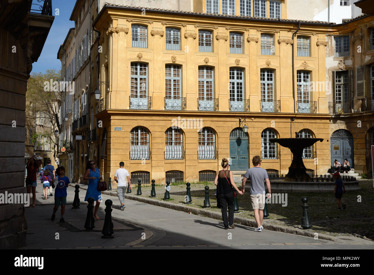 Young Couple Walk Hand in Hand Past the Place d'Albertas Historic Town Square Aix-en-Provence Provence France Stock Photo