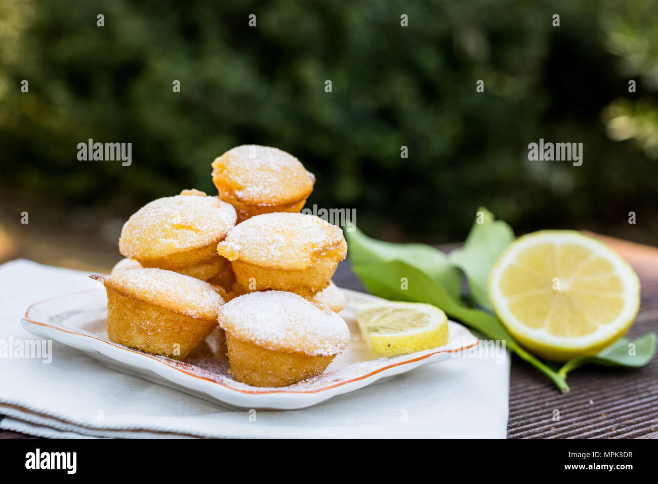 lemon butter teacakes with cut lemon in the backyard Stock Photo