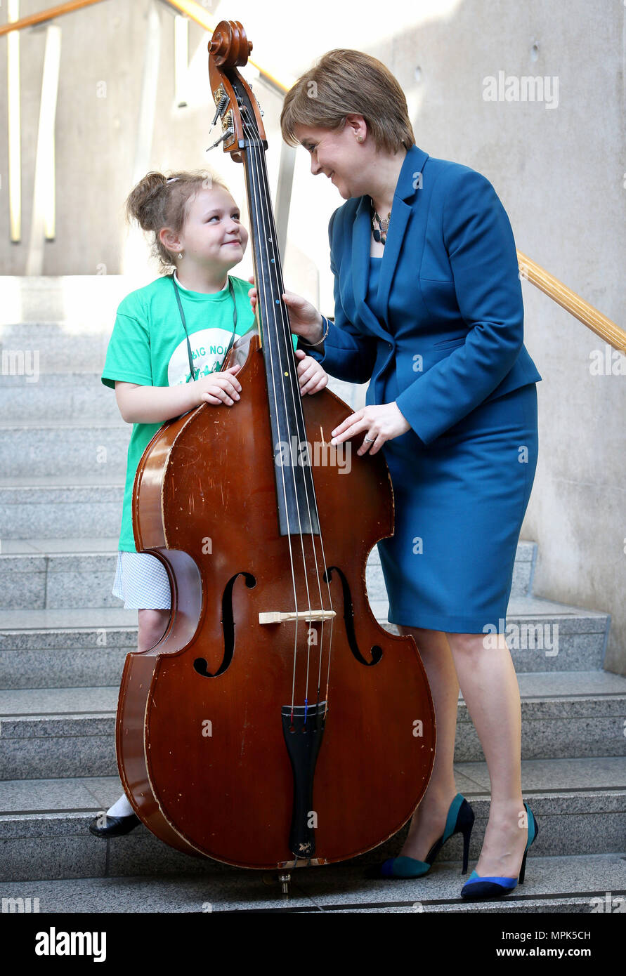 First Minister of Scotland Nicola Sturgeon with double-bass player Martyna Szwabowicz, seven, from Dundee, as they celebrate the 10th birthday of charity Sistema Scotland during its Big Noise programme which aims to transform the lives of children living in disadvantaged communities through music. Stock Photo