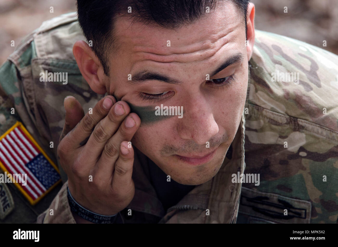 A Soldier applies camouflage face paint during preparation for the Expert  Infantryman Badge (EIB) at Fort Jackson. Training includes proper  application techniques on the face and equipment to reduce visual detection  and