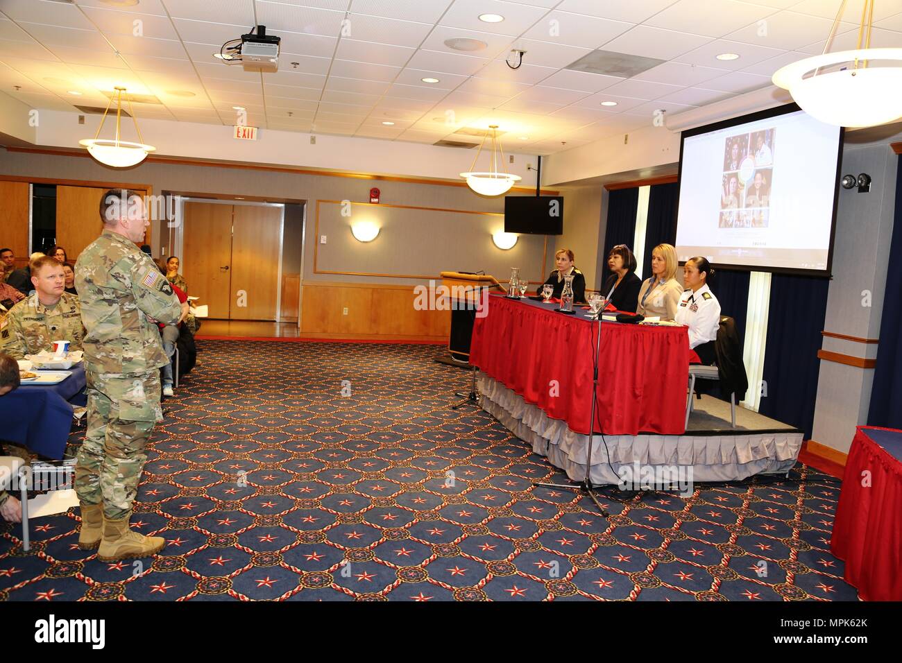 A Fort McCoy community member asks the guest speaker panel a question during the installation observance of Women’s History Month on March 16, 2017, at McCoy’s Community Center at Fort McCoy, Wis. The panel featured Capt. Kimberly Elenberg with the U.S. Public Health Service at the Pentagon, Pastor Ethell Tillis with the Tomah (Wis.) Pentecostal Assembly, Lori Freit-Hammes with the Mayo Clinic Health System-Franciscan Healthcare in La Crosse, and 1st Sgt Leah Mariano with the Staff Sgt. Todd R. Cornell Noncommissioned Officer Academy. (U.S. Army Photo by Scott T. Sturkol, Public Affairs Office Stock Photo